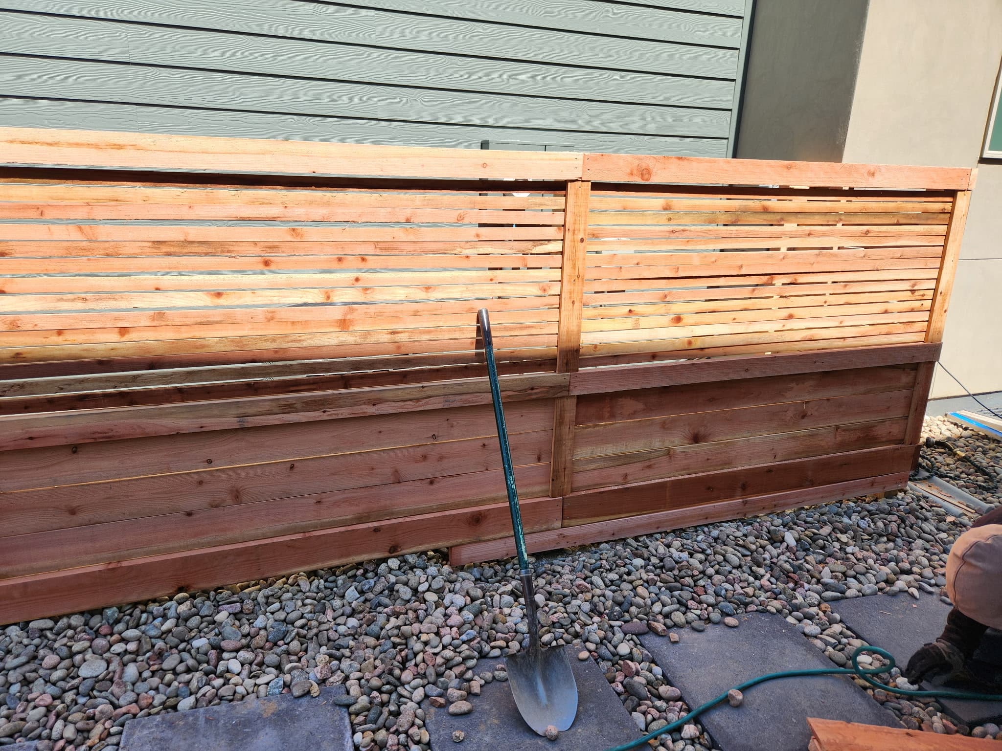 Wood privacy fence along a green lawn